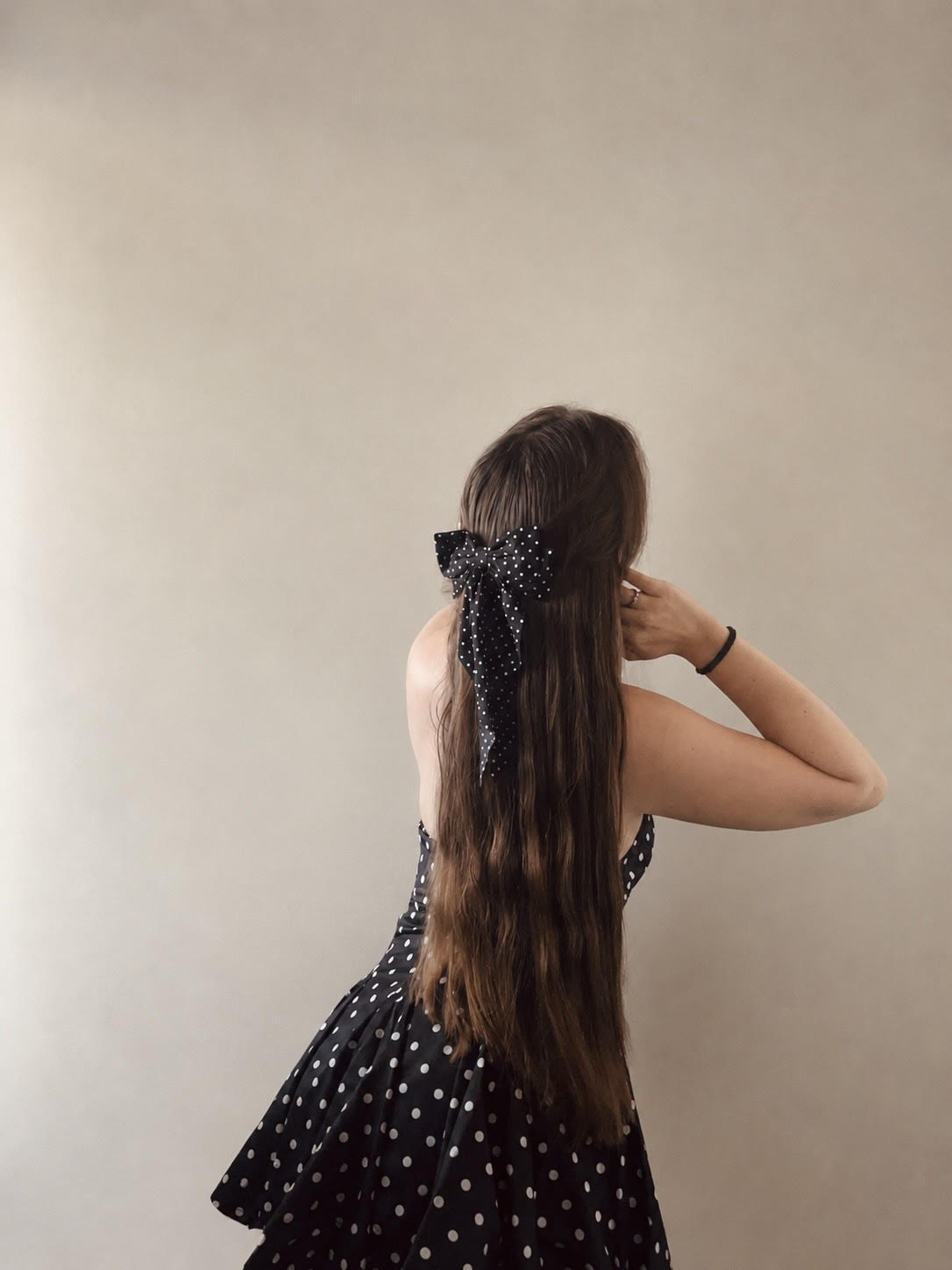 Long flowing hair styled with a soft pink ribbon